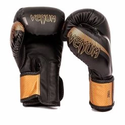 Venum Impact Boxing Gloves – Black/Bronze 5 Venum Impact Boxing Gloves – Black/Bronze -Knockout Deals on Boxing Gear fc5a5920af294fe1c84392955057a8f92fdc4ff1 BG IMPACT BLACK BRONZE 02